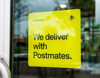 A yellow sticker decal advertising Postmates delivery service